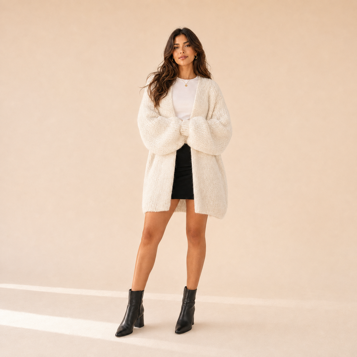 Woman modeling The Sienne Cloud Cardigan in Ivory